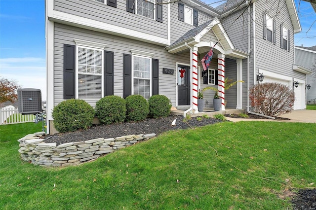 view of front facade with a garage and a front lawn