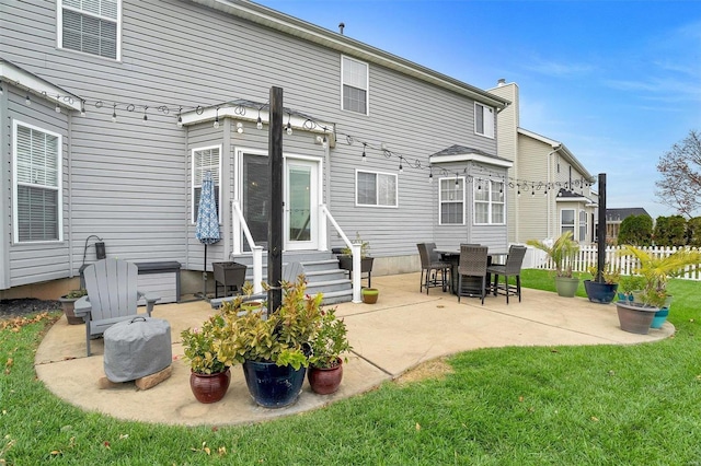 rear view of property with a patio area and a yard