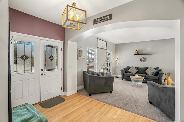 entryway featuring hardwood / wood-style floors and a notable chandelier