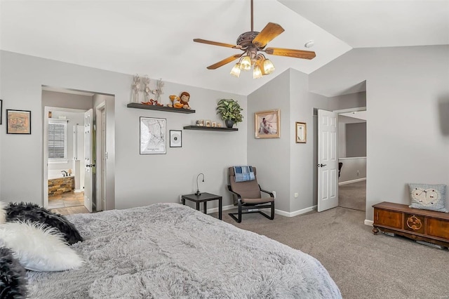 bedroom featuring ceiling fan, connected bathroom, vaulted ceiling, and light carpet