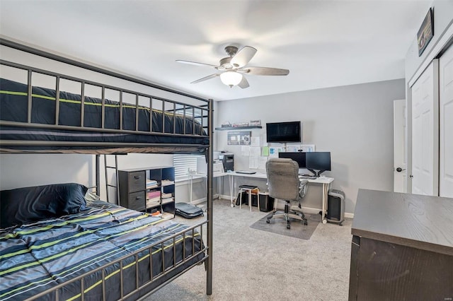 carpeted bedroom with ceiling fan and a closet