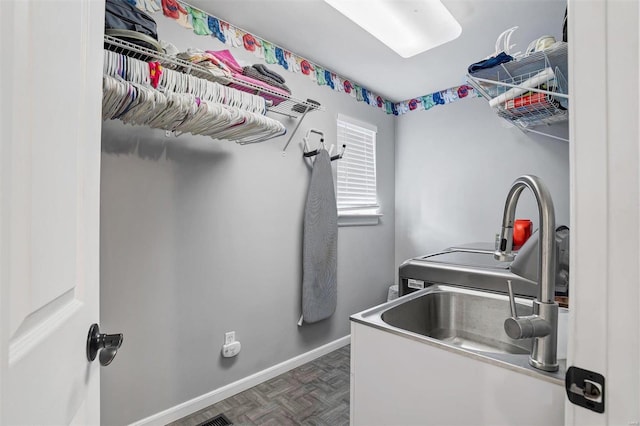 washroom featuring dark parquet flooring and sink