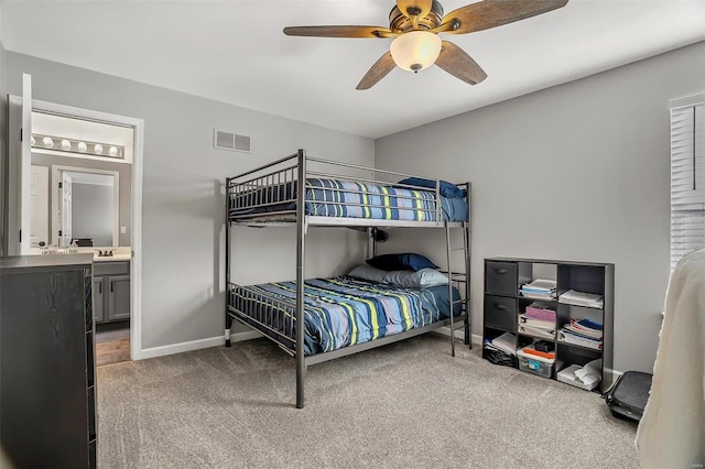 carpeted bedroom with ceiling fan and connected bathroom