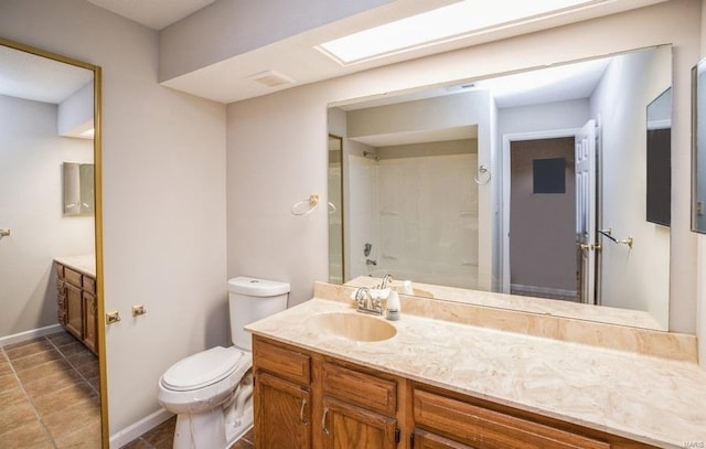 full bathroom featuring vanity, a skylight, tile patterned flooring, toilet, and tub / shower combination