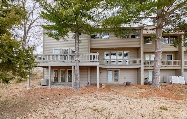 back of house with central AC and a deck