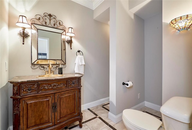 bathroom featuring tile patterned floors, toilet, vanity, and ornamental molding