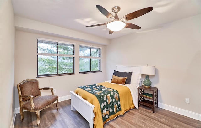 bedroom with ceiling fan and dark hardwood / wood-style flooring