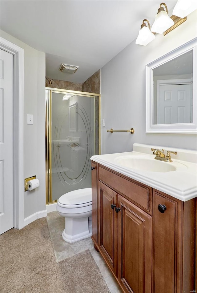 bathroom featuring tile patterned flooring, vanity, an enclosed shower, and toilet