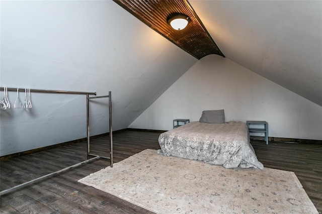 bedroom featuring dark hardwood / wood-style flooring and lofted ceiling