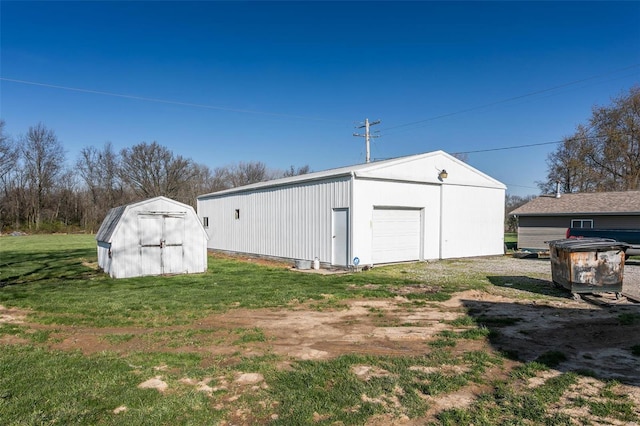 view of outdoor structure with a garage and a lawn