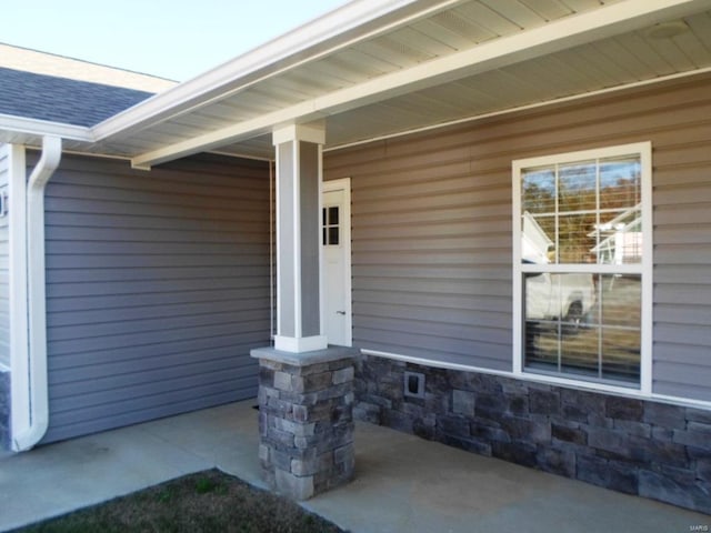 view of exterior entry featuring a porch