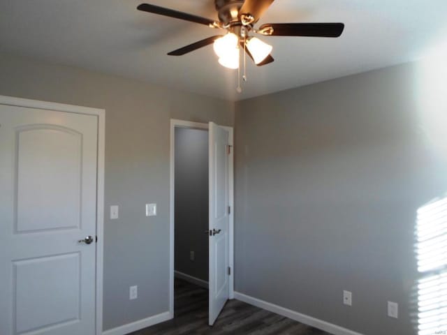 unfurnished bedroom featuring dark hardwood / wood-style flooring and ceiling fan