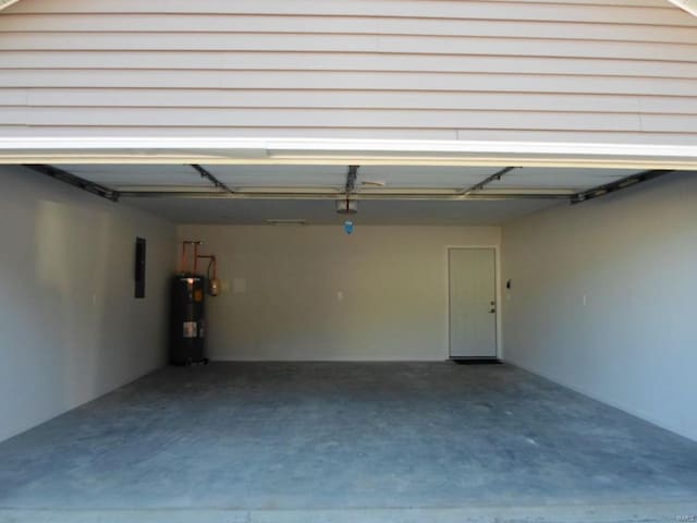 garage with electric panel and water heater