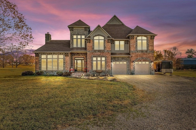 view of front of property with a lawn and a garage