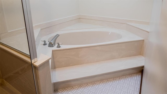 bathroom featuring tile patterned floors and a bathing tub