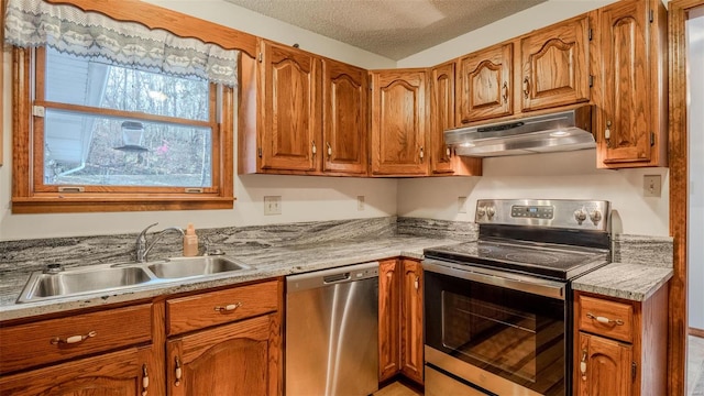 kitchen featuring a textured ceiling, sink, and appliances with stainless steel finishes