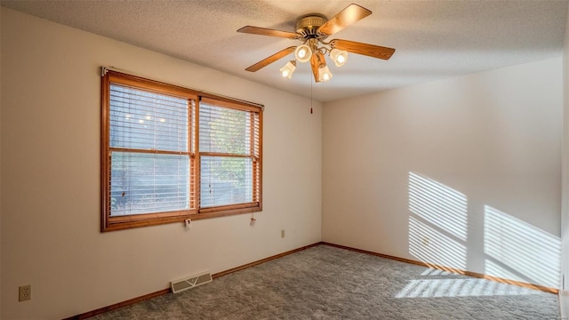 carpeted empty room featuring a textured ceiling and ceiling fan