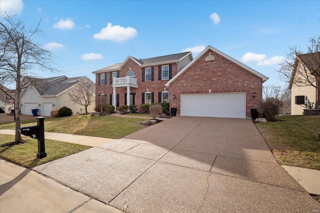 view of front of home featuring brick siding, concrete driveway, a front yard, a garage, and a balcony