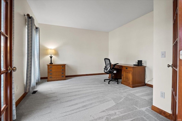 office with visible vents, light colored carpet, and baseboards