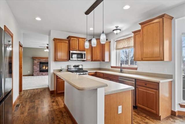 kitchen with a center island, light countertops, recessed lighting, stainless steel appliances, and a sink