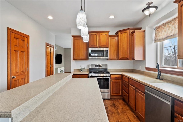 kitchen featuring stainless steel appliances, light countertops, and a sink