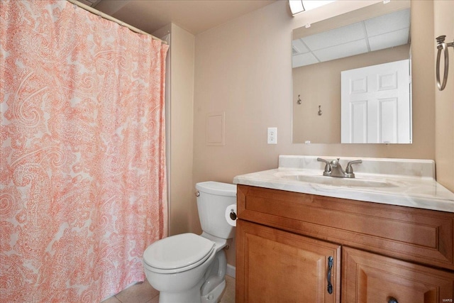 bathroom featuring a drop ceiling, toilet, a shower with shower curtain, tile patterned floors, and vanity