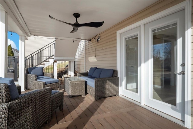 wooden deck with ceiling fan and outdoor lounge area