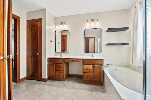 full bath featuring carpet flooring, a sink, a garden tub, and double vanity