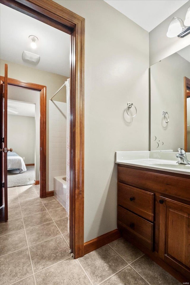 full bathroom with tile patterned floors, baseboards, vanity, and bathtub / shower combination