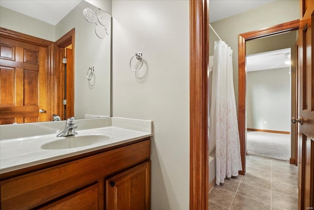 bathroom featuring tile patterned floors, baseboards, vanity, and shower / bath combination with curtain