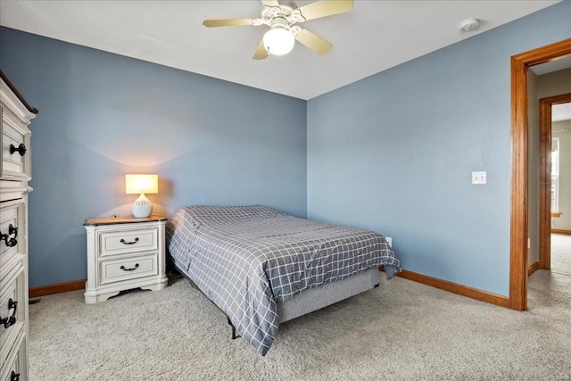 bedroom with baseboards, light carpet, and a ceiling fan