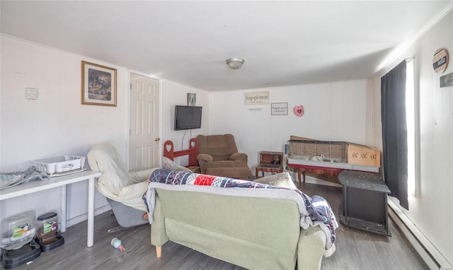 living room featuring wood-type flooring and a baseboard heating unit