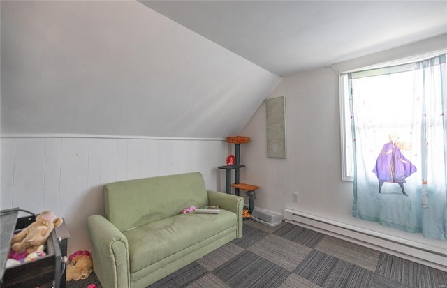 living area featuring a baseboard heating unit and vaulted ceiling