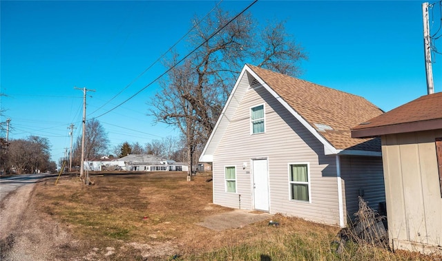 rear view of property with a lawn