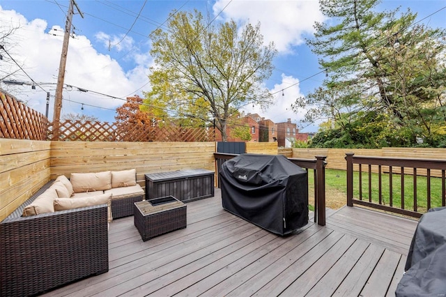 wooden terrace with outdoor lounge area, area for grilling, and a lawn