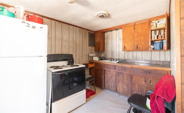 kitchen featuring sink, white appliances, wooden walls, electric panel, and a textured ceiling