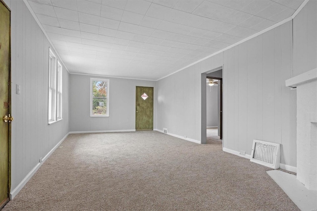 empty room with carpet flooring and crown molding