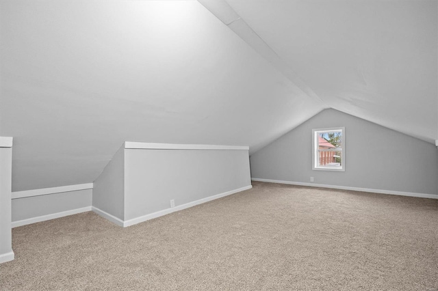 additional living space with carpet and vaulted ceiling