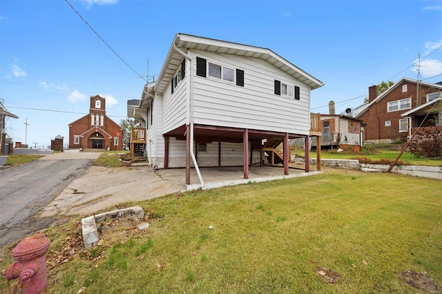 rear view of property with a yard