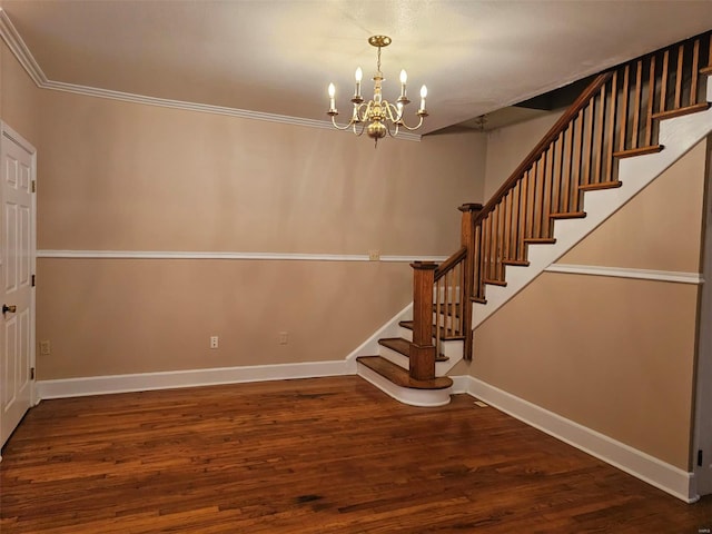 stairway with hardwood / wood-style floors, a notable chandelier, and crown molding