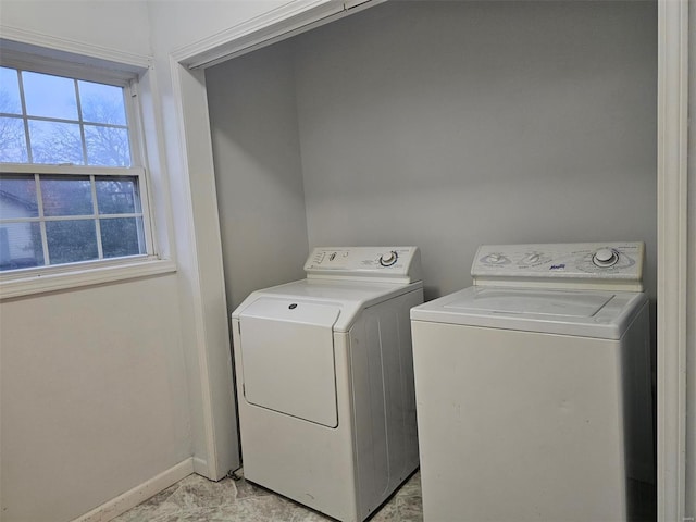 clothes washing area with separate washer and dryer