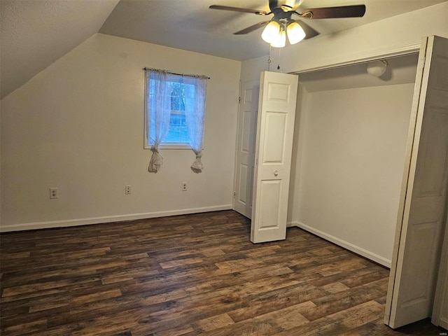 unfurnished bedroom featuring dark hardwood / wood-style floors, vaulted ceiling, and ceiling fan