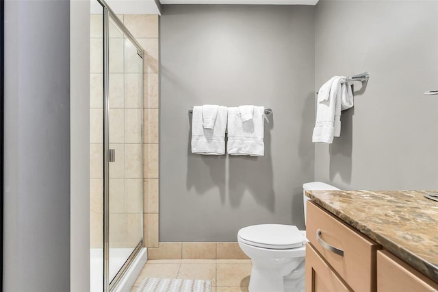 bathroom featuring tile patterned flooring, vanity, toilet, and an enclosed shower