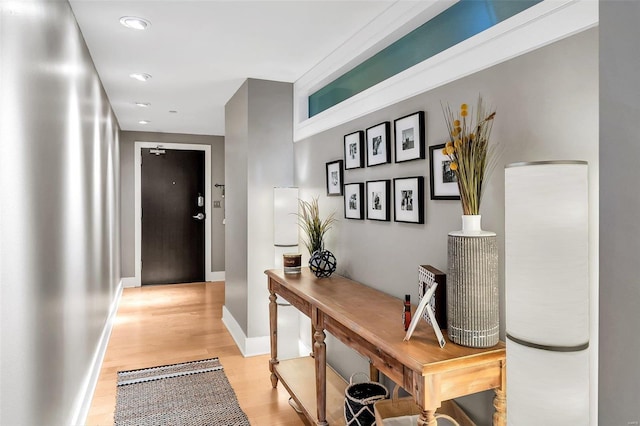 hallway with light hardwood / wood-style flooring