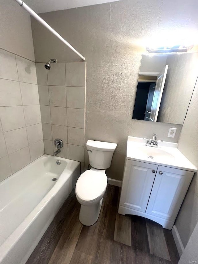 full bathroom with wood-type flooring, vanity, toilet, and tiled shower / bath