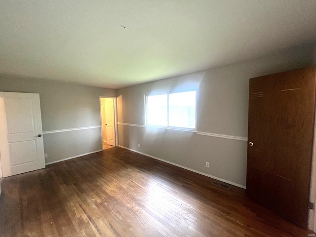 unfurnished room featuring dark hardwood / wood-style floors