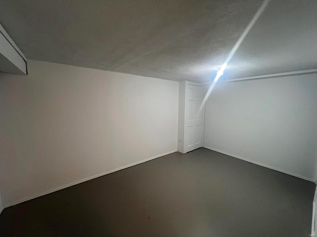 bonus room featuring a textured ceiling