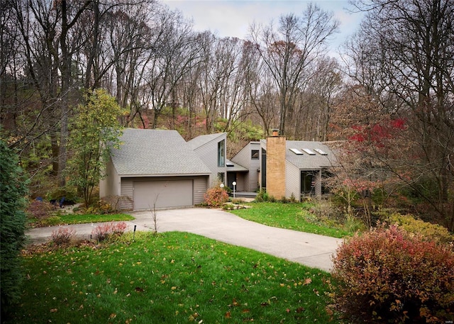 view of front of home with a garage and a front yard