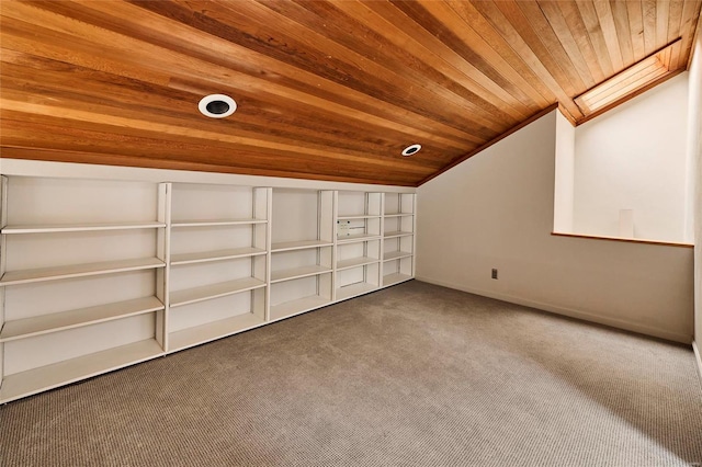 additional living space featuring carpet flooring, lofted ceiling with skylight, and wooden ceiling