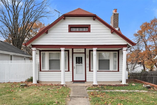 bungalow-style house with a front yard